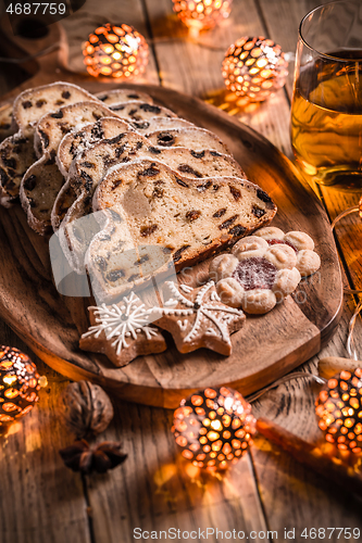 Image of Christmas Stollen with apple mulled wine. Traditional Sweet Fruit Loaf with icing sugar.  