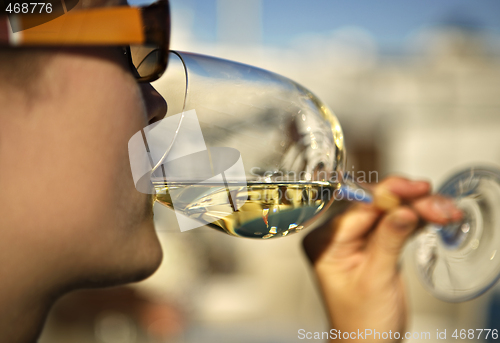 Image of Woman sipping a glass of white wine