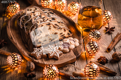 Image of Christmas Stollen with apple mulled wine. Traditional Sweet Fruit Loaf with icing sugar.  