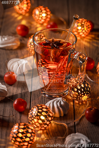 Image of Spicy winter tea or punch with anise and meringue pastry