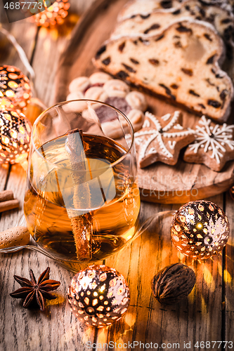 Image of Apple mulled wine with Christmas Stollen. Traditional Sweet Fruit Loaf with icing sugar.  