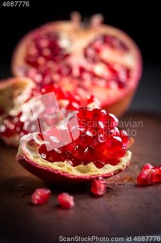 Image of Fresh organic pomegranate on wooding cutting board