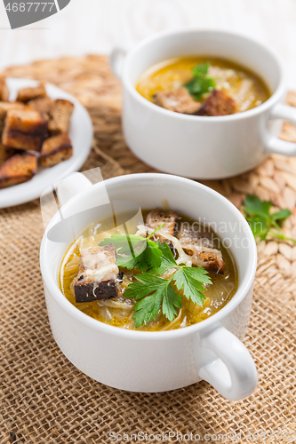 Image of Traditional French onion soup with toasted bread croutons 