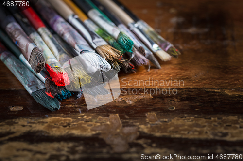 Image of Artist vintage paint brushes on wooden background