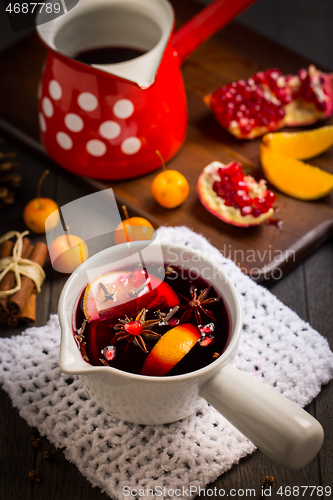 Image of Hot spicy mulled wine with fruits and spices in mug