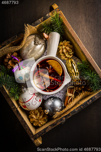 Image of Mulled wine with orange, cinnamon and anise in mug for Christmas