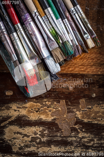 Image of Artist vintage paint brushes on wooden background