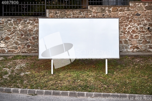 Image of Empty singboard by a road