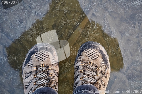 Image of Standing on ice of frozen lake