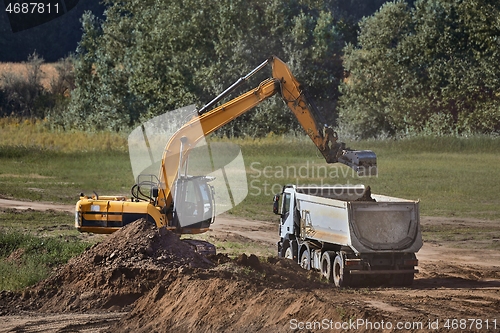 Image of Construction site excavator and truck