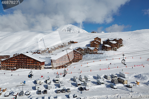 Image of Snowy mountain skiing village, falling snow