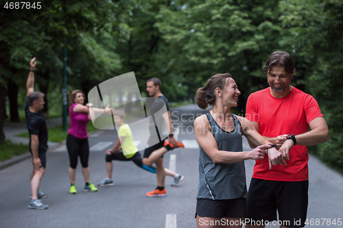 Image of sporty couple using smart watches