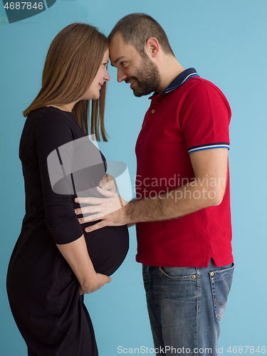 Image of pregnant couple  isolated over blue background