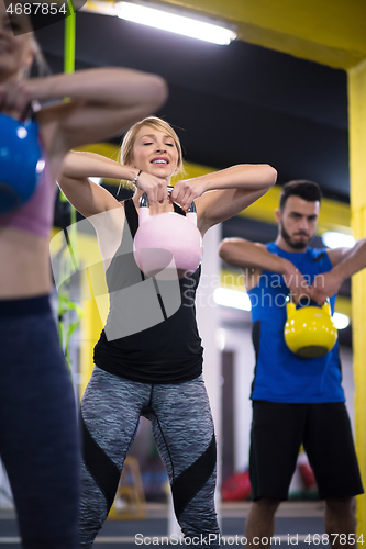 Image of athletes doing exercises with kettlebells