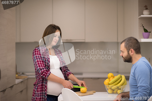 Image of couple cooking food fruit lemon juice at kitchen