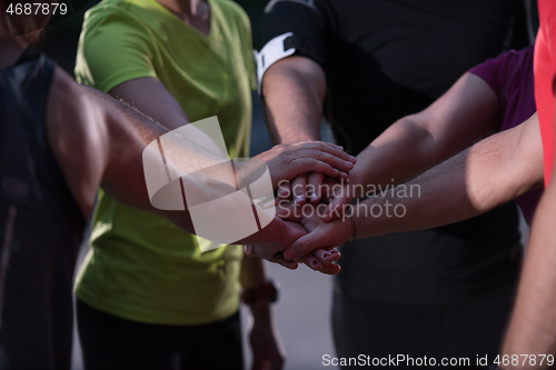 Image of runners giving high five to each other