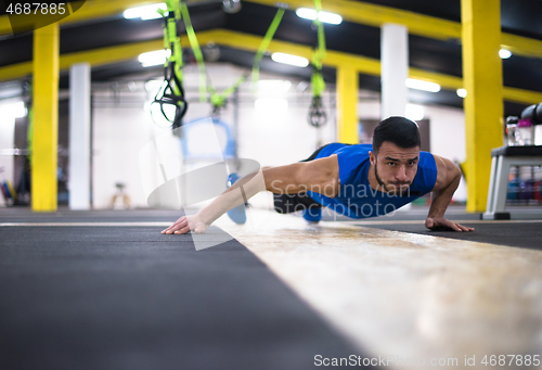 Image of Young  man doing pushups