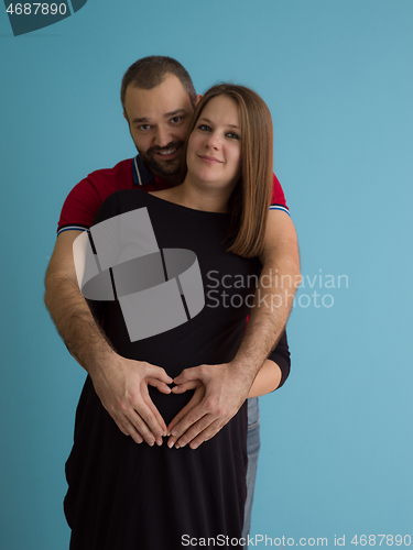 Image of pregnant couple  isolated over blue background