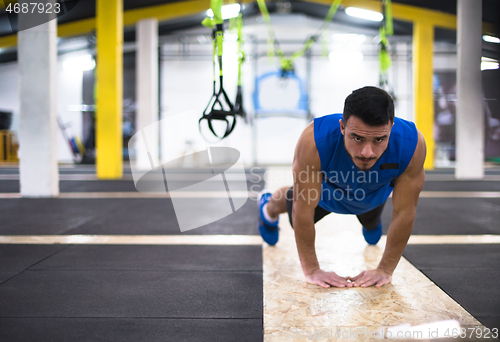 Image of Young  man doing pushups