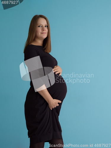 Image of Portrait of pregnant woman over blue background