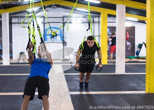 Image of men working out pull ups with gymnastic rings