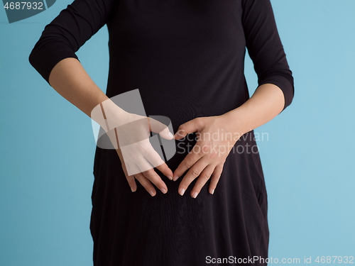 Image of Portrait of pregnant woman over blue background