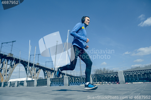 Image of Man running on city background at morning.