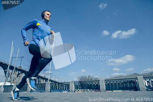 Image of Man running on city background at morning.