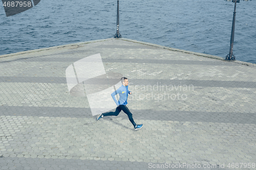 Image of Man running on city background at morning.