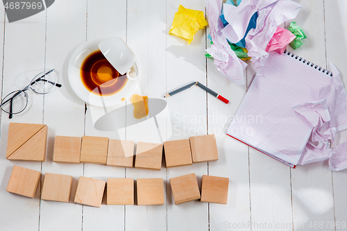 Image of Message in wooden cubes on a desk background.