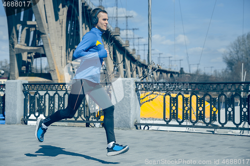 Image of Man running on city background at morning.