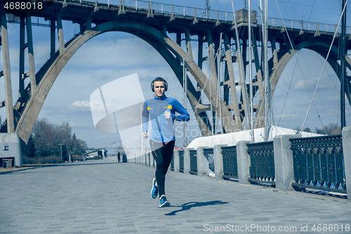 Image of Man running on city background at morning.