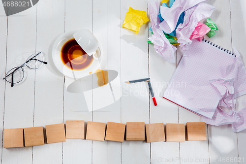 Image of Message in wooden cubes on a desk background.