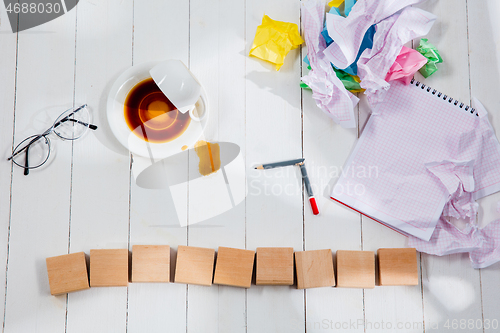 Image of Message in wooden cubes on a desk background.