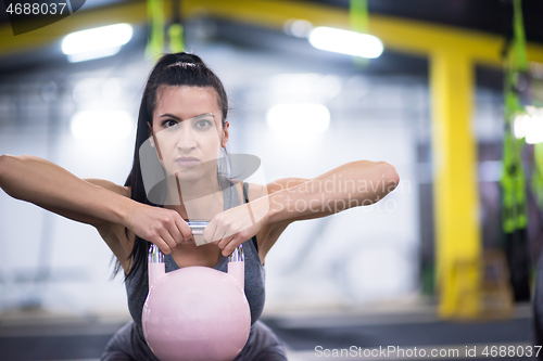 Image of woman exercise with fitness kettlebell