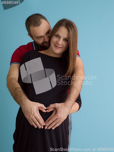 Image of pregnant couple  isolated over blue background