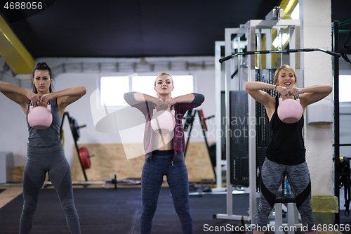 Image of athletes doing exercises with kettlebells