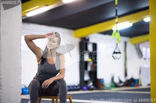 Image of young athlete woman sitting and relaxing