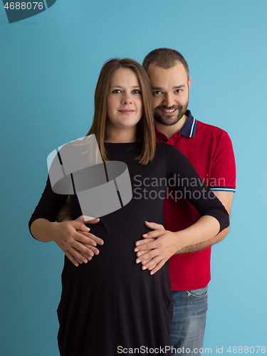 Image of pregnant couple  isolated over blue background