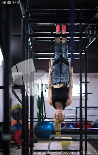 Image of woman working out on gymnastic rings