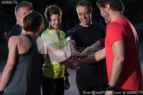 Image of runners giving high five to each other