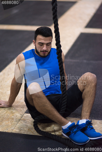 Image of man relaxing before rope climbing