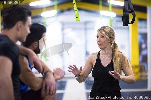 Image of athletes working out  jumping on fit box