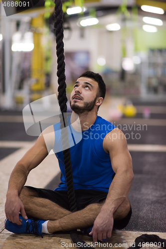 Image of man relaxing before rope climbing