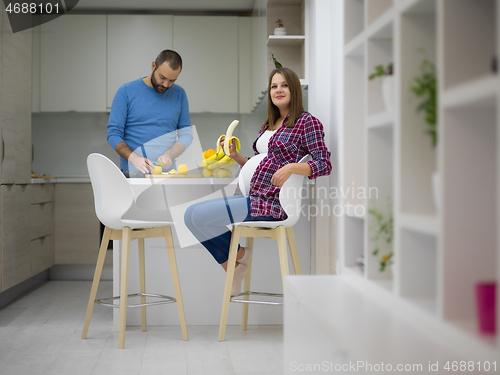 Image of couple cooking food fruit lemon juice at kitchen