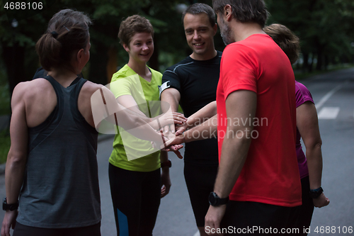 Image of runners giving high five to each other