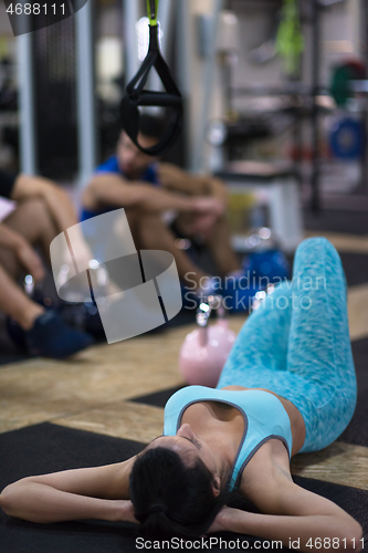 Image of young athlete woman lying on the floor and relaxing