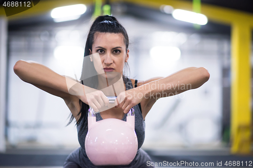 Image of woman exercise with fitness kettlebell