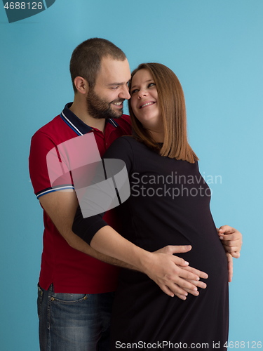 Image of pregnant couple  isolated over blue background