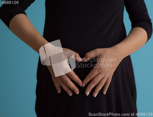 Image of Portrait of pregnant woman over blue background